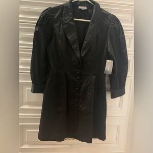 Stylish black dress with full button front and sleeves trimmed with buttons.